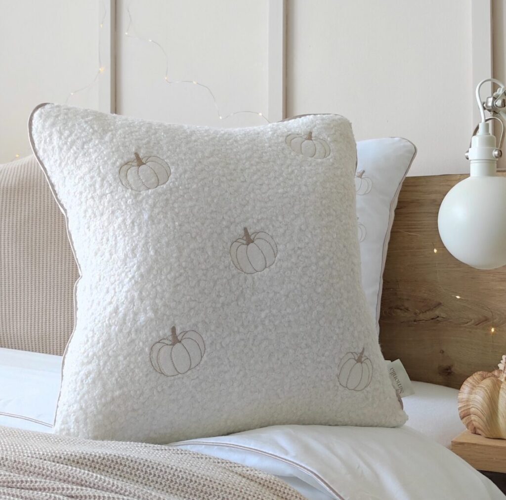 Jesienna poduszka z pięcioma haftowanymi dyniami w odcieniach biało-beżowych bestseller kolekcji Simonila, elegancka dekoracyjna salonu i sypialni